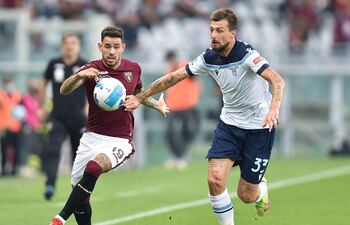El paraguayo Antonio Sanabria (i), del Torino, disputa el balón con Francesco Acerbi, de Lazio.