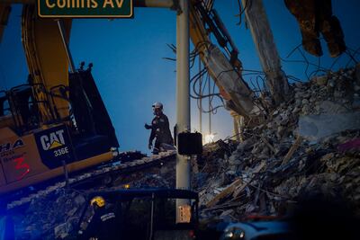 Search and rescue teams continue to work in the rubble at the site of the collapsed Champlain Towers South condo in Surfside, Florida, on July 6, 2021. - Rescuers on combed through the debris of a deadly condo tower collapse in Florida as Tropical Storm Elsa threatened to complicate the delicate search mission with strong winds and heavy rain. The death toll from the June 24 disaster in Surfside, a town north of Miami Beach, rose to 36 as search teams found four more bodies in the rubble, Miami-Dade County Mayor Daniella Levine Cava said. (Photo by Eva Marie UZCATEGUI / AFP)