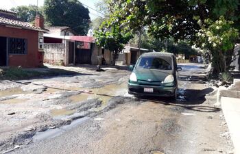 Un auto debe transitar en sentido contrario para eludir los baches de la calle San Rafael.