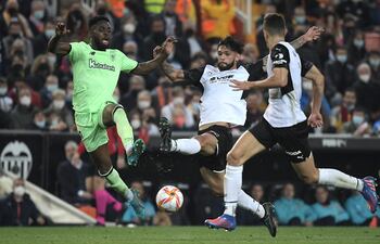Omar Alderete, defensor paraguayo del Valencia, rechaza el balón ante la presencia del delantero español Iñaki Williams, del Athletic Bilbao.