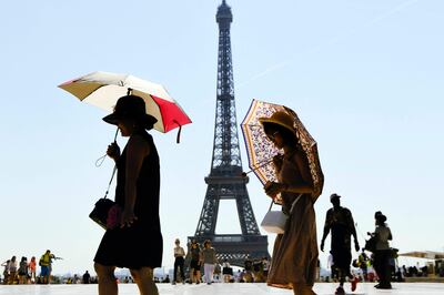 Turistas pasean por Trocadero, frente a la Torre Eiffel, en París.