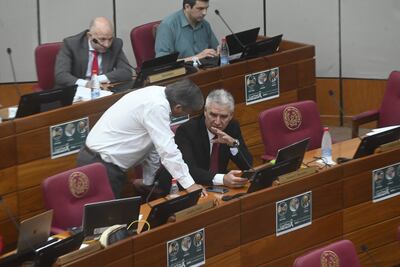 El senador José Pakova Ledesma (PLRA) conversa con el senador Enrique Bacchetta (ANR, FR), en la sala de sesiones del Senado.