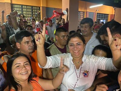 Liz Meza, de camisa blanca, festeja su ajustada victoria.