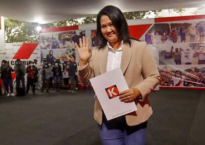 Keiko Fujimori waving as she arrives to the Fuerza Popular party's headquarters in Lima on July 19, 2021