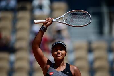 TOPSHOT - Japan's Naomi Osaka celebrates after winning against Romania's Patricia Maria Tig during their women's singles first round tennis match on Day 1 of The Roland Garros 2021 French Open tennis tournament in Paris on May 30, 2021. (Photo by MARTIN BUREAU / AFP)