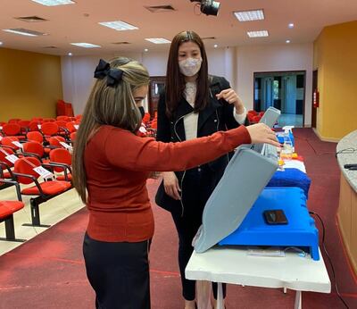 Una funcionaria del TSJE realizando capacitaciones sobre el uso de las máquinas de votación.