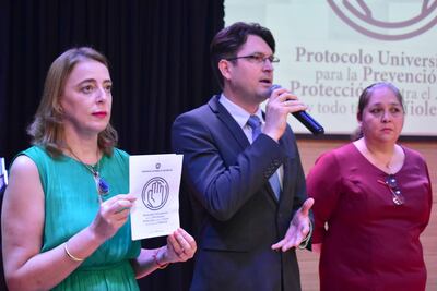 El decano de la Facultad de Derecho, Yoni Flick, explica en qué consiste el protocolo. Observan Nadia Czeraniuk, rectora, y Graciela Vera, de Bienestar Universitario.