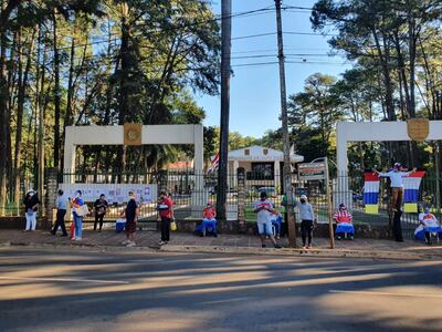 Un grupo de manifestante se encadena por la reja de la Gobernación del Alto Paraná para exigir asistencia de alimentos.