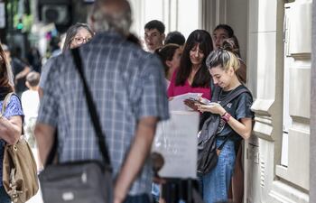 Personas hacen fila frente al consulado español en Buenos Aires (Argentina).