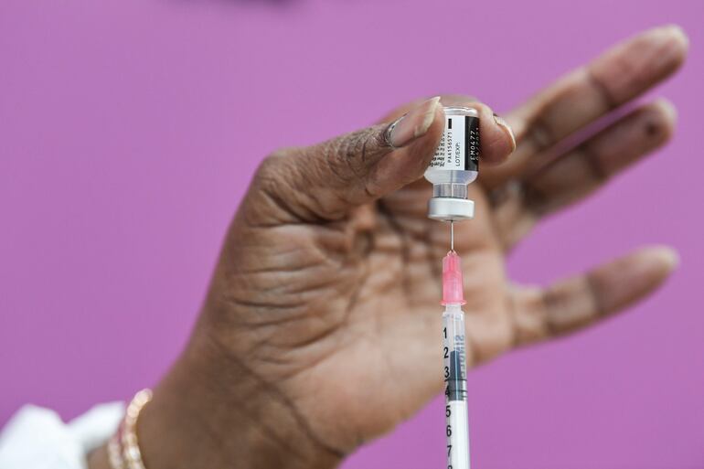 A nurse prepares the Pfizer-BioNTech Covid-19 vaccine, at a vaccination center, in Sarcelles near Paris on January 10, 2021. (Photo by ALAIN JOCARD / AFP)
