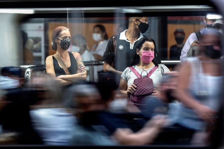 Pasajeros con tapabocas  en la estación de metro de Sé, en el centro de São Paulo, Brasil.