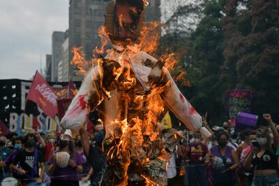 Una imagen del presidente brasileño Jair Bolsonaro se quema durante las protestas exigiendo su renuncia, en Sao Paulo, Brasil, el 2 de octubre de 2021. Las protestas en Río de Janeiro, Salvador, Sao Paulo y Brasilia, además de un centenar de ciudades, fueron convocada por la "Campaña Nacional Fuera Bolsonaro", respaldada por una decena de partidos de izquierda, centrales sindicales y el grupo Direitos Já!