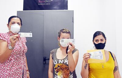 Usuarias que acudieron a las oficinas de G5Pro exhiben sus entradas para el festival Asunciónico, suspendido a causa del covid-19.