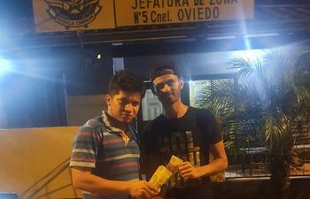 Vicente "Jakare" Seanger y Edison López "Takumbu Revoque", posando con la suma que abonaron en concepto de multa a la Patrulla Caminera.