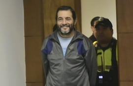 El médico cirujano Miguel Ángel Cavallo, ingresa sonriente a la sala de juicios.