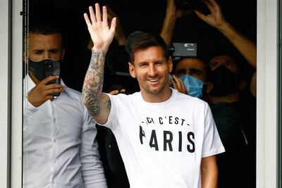 Argentinian football player Lionel Messi waves to supporters from a window after he landed on August 10, 2021 at Le Bourget airport, north of Paris, as Paris Saint-Germain look to complete the 34-year-old signing following his departure from Barcelona, the club he has represented for the entirety of his 17-year professional career so far. - Asked by reporters at Barcelona's El Prat airport if the Argentine star would later on sign with the French club, Jorge Messi, the father and player's agent, said: "Yes". (Photo by Sameer Al-DOUMY / AFP)