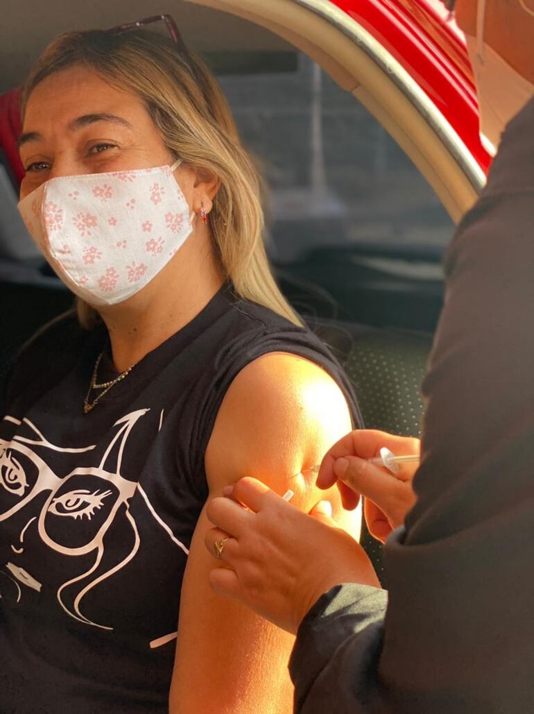 Una mujer recibe la dosis de la vacuna anticovid en el vacunatorio del Cerro Ñemby de la ciudad del mismo nombre. cientos de trabajadores esenciales llegaron hasta este lugar desde el día de ayer.