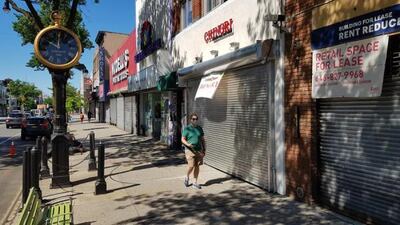 Una persona camina frente a negocios cerrados pese a reapertura, en la quinta Avenida en Nueva York (Estados Unidos).