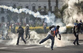 Manifestantes se enfrentan con la policía durante una jornada de marchas contra la presidencia de Dina Boluarte, esta semana en Lima (Perú). Exigen la marcha de un Gobierno que consideran "asesino" y "dictatorial" por la muerte de 46 manifestantes en enfrentamientos con las fuerzas del orden.