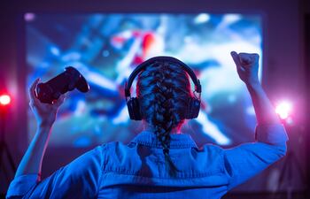 Girl,In,Headphones,Plays,A,Video,Game,On,The,Big