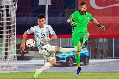 El arquero chileno Claudio Bravo rechaza el balón ante la arremetida del delantero argentino Lautaro Martínez. AFP