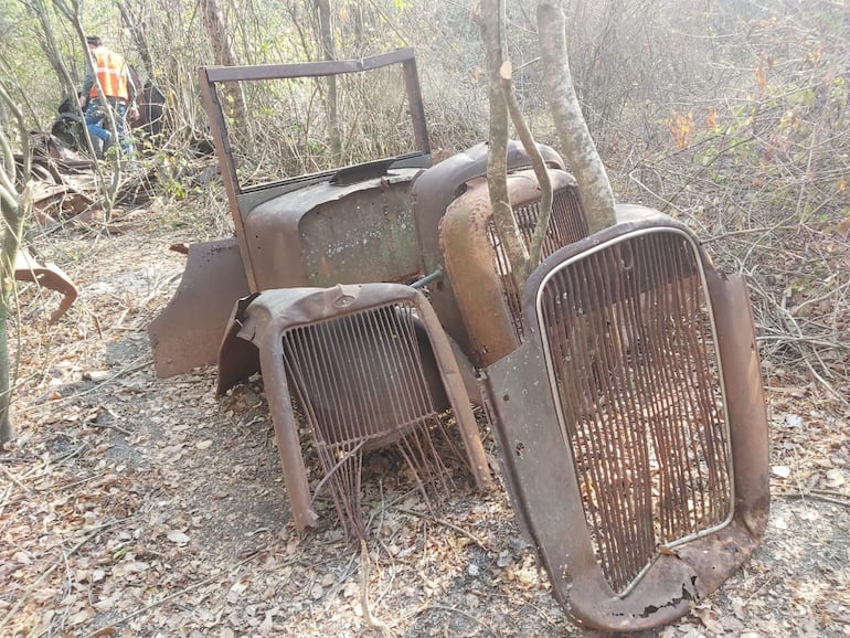 En el fondo, uno de los obreros sigue recorriendo en búsqueda de pedazos del camión. Se notan partes del rodado.