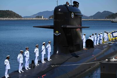 Members of the Navy stand on the first Riachuelo Class Submarine S-40 ready to operate as it is being delivered to the Brazilian Navy by Itaguai Naval Construction (ICN), a French-Brazilian company in charge of building the submarines of the Brazilian Submarine Development Program (PROSUB), during a ceremony at the naval base located in Itaguai, Rio de Janeiro State, Brazil, on September 1, 2022. (Photo by Mauro PIMENTEL / AFP)