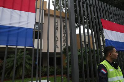 Un policía vigila el edificio de Justicia Electoral, institución que prosigue hoy con el juzgamiento de actas tras las elecciones del domingo último.