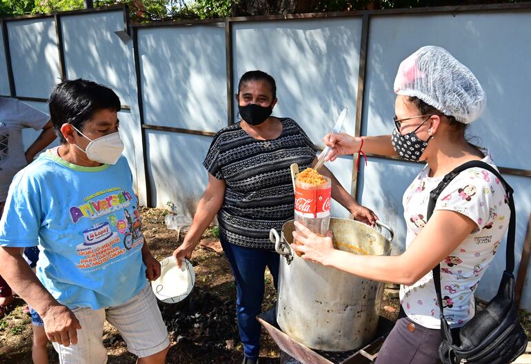 Mucha gente se acercó con su recipiente para retirar la comida de la gran olla popular en honor a San Cayetano.