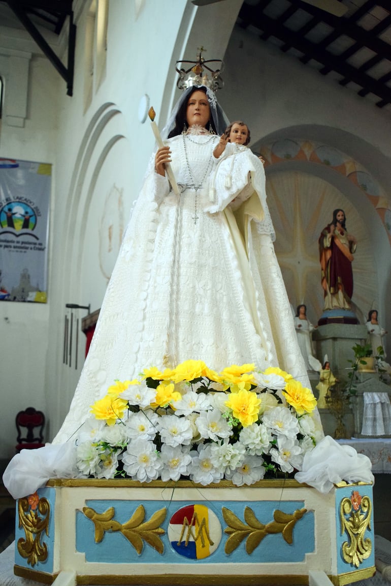La devoción a la Virgen de la Candelaria viene de España. Porta una vela en la mano y en el brazo carga al Niño.
