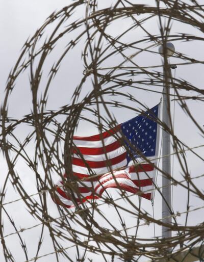 (FILES) In this file photoa US flag flies at Camp V inside Camp Delta in US Naval Station in Guantanamo Bay, Cuba, on April 24, 2007. - The prosecution of alleged September 11 mastermind Khalid Sheikh Mohammed and four others restarts on September 7, 2021, just days before the 20th anniversary of the attacks, stirring new hopes for justice and retribution. Mohammed and his co-defendants, who have been locked up at the "War on Terror" prison at the US naval base in Guantanamo Bay, Cuba for nearly 15 years, will appear in the military tribunal here for the first time since early 2019. (Photo by Paul J. RICHARDS / AFP)