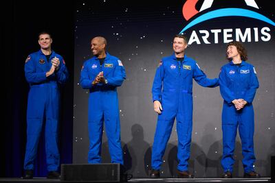 (L-R) Astronauts Jeremy Hansen, Victor Glover, Reid Wiseman and Christina Hammock Koch stand onstage after being selected for the Artemis II mission who will venture around the Moon during a news conference held by NASA and CSA at NASA Johnson Space Centers Ellington Field in Houston, Texas, on April 3, 2023. - Traveling aboard NASAs Orion spacecraft during Artemis II, the mission is the first crewed flight test on the agencys path to establishing a long-term scientific and human presence on the lunar surface. (Photo by Mark Felix / AFP)