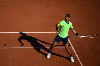 Spain's Rafael Nadal returns the ball to Australia's Alexei Popyrin during their men's singles first round tennis match on Day 3 of The Roland Garros 2021 French Open tennis tournament in Paris on June 1, 2021. (Photo by Christophe ARCHAMBAULT / AFP)