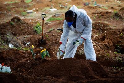 Trabajadores llevan a cabo el entierro de una víctima de la covid-19 en el Cementerio Vila Formosa el 11 de marzo de 2021, en Sao Paulo (Brasil). El país superó hoy las 2.300 muertes diarias por la enfermedad.
