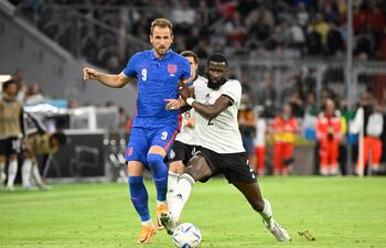 Harry Kane (i), capitán de Inglaterra, disputa el balón con el defensor alemán Antonio Rüdiger.