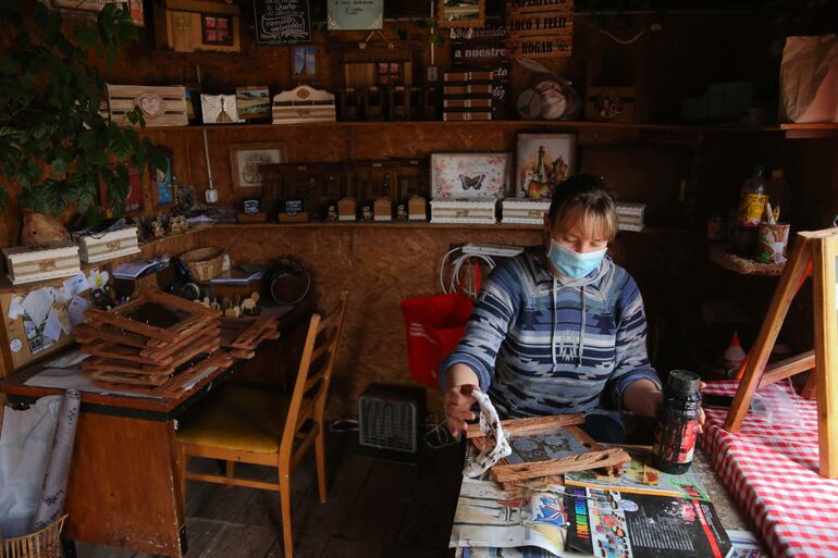 La artesana Micaela Kramer trabaja en una pieza dentro del antiguo vagón de tren que sirve de taller a su grupo en el pueblo de Chapicuy, en el departamento de Paysandú (Uruguay).