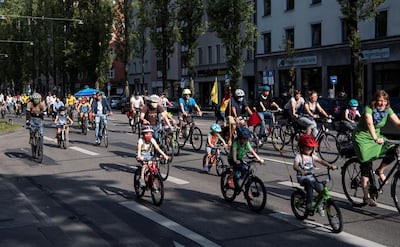 Ciclistas de todas las edades, con barbijos, pedalean en las calles de Munich, Alemania.