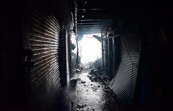 La luz en el final de este acceso deja ver lo angosto que es el camino, los cables sueltos y varios depósitos muy pegados.