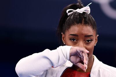TOPSHOT - USA's Simone Biles gestures during the artistic gymnastics women's team final during the Tokyo 2020 Olympic Games at the Ariake Gymnastics Centre in Tokyo on July 27, 2021. (Photo by Loic VENANCE / AFP)
