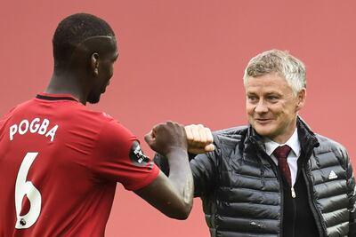 Manchester United's Norwegian manager Ole Gunnar Solskjaer (R) congrtulates Manchester United's French midfielder Paul Pogba during the English Premier League football match between Manchester United and Bournemouth at Old Trafford in Manchester, north west England, on July 4, 2020. (Photo by PETER POWELL / POOL / AFP) / RESTRICTED TO EDITORIAL USE. No use with unauthorized audio, video, data, fixture lists, club/league logos or 'live' services. Online in-match use limited to 120 images. An additional 40 images may be used in extra time. No video emulation. Social media in-match use limited to 120 images. An additional 40 images may be used in extra time. No use in betting publications, games or single club/league/player publications. / 