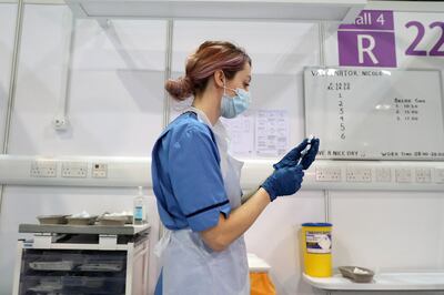 Una trabajadora médica se prepara para administrar una dosis de vacuna contra la covid-19 en un hospital en Glasgow, Reino Unido.