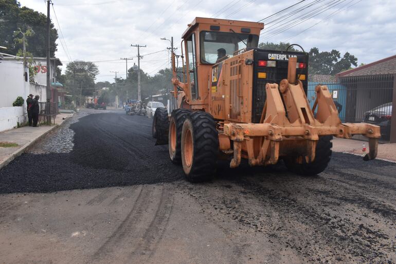 Momento en que una maquina del mopc da inicio a los trabajos de regularización asfáltica en la ciudad de Ñemby, con la presencia del presidente y vicepresidente de la república.
