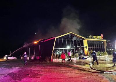 Una foto de un folleto publicada por la fundación de rescate Sawang Rojana Thammasathan muestra a los rescatistas y bomberos extinguiendo un incendio en el club nocturno Mountain B en el distrito de Sattahip, provincia de Chonburi, Tailandia.