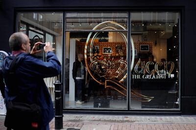 A man takes a picture walk of a new store selling official merchandise of legendary British rock group Queen in central London