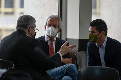 El periodista guatemalteco José Rubén Zamora, director de El Periódico, habla con sus abogados en un salón del Poder Judicial de su país.  (AFP)
