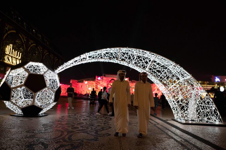 TOPSHOT - People walk along at Katara Cultural Village in Doha on November 17, 2022, ahead of the Qatar 2022 World Cup football tournament. (Photo by PABLO PORCIUNCULA / AFP)