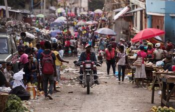 Personas circulan durante el atardecer por el mercado de Pétion-Ville, este domingo en Puerto Príncipe (Haití). La actividad en las calles de Puerto Príncipe no cesa con la caída del sol, a pesar del estado de sitio declarado por el Gobierno como consecuencia del asesinato del presidente Jovenel Moise, el pasado 7 de julio, que ha desencadenado una crisis de todavía incierta solución.