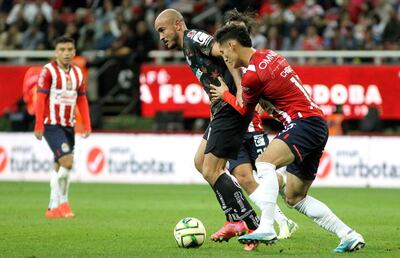 Carlos González domina el balón ante la marca de Jesús Orozco, de las Chivas, durante el partido que Toluca ganó 2-1 con una anotación del delantero paraguayo.