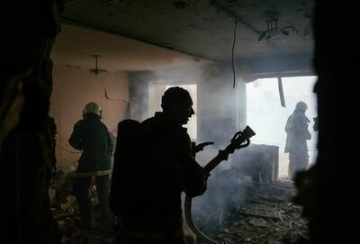 TOPSHOT - Firefighters put out the fire in a destroyed house after a shelling in Bakhmut, Donetsk region on August 13, 2022, amid the Russian military invasion of Ukraine. (Photo by ANATOLII STEPANOV / AFP)