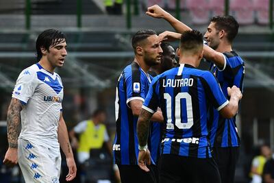 Inter Milan's Italian defender Danilo D'Ambrosio (C) celebrates with Inter Milan's Italian midfielder Roberto Gagliardini (R) and Inter Milan's Argentinian forward Lautaro Martinez after scoring the third goal during the Italian Serie A football match Inter vs Brescia played behind closed doors on July 1, 2020 at the Giuseppe-Meazza San Siro stadium in Milan, as the country eases its lockdown aimed at curbing the spread of the COVID-19 infection, caused by the novel coronavirus. (Photo by Miguel MEDINA / AFP)